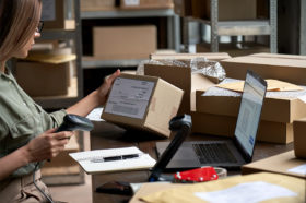 Woman scanning box: Inventory Management Strategy on Amazon